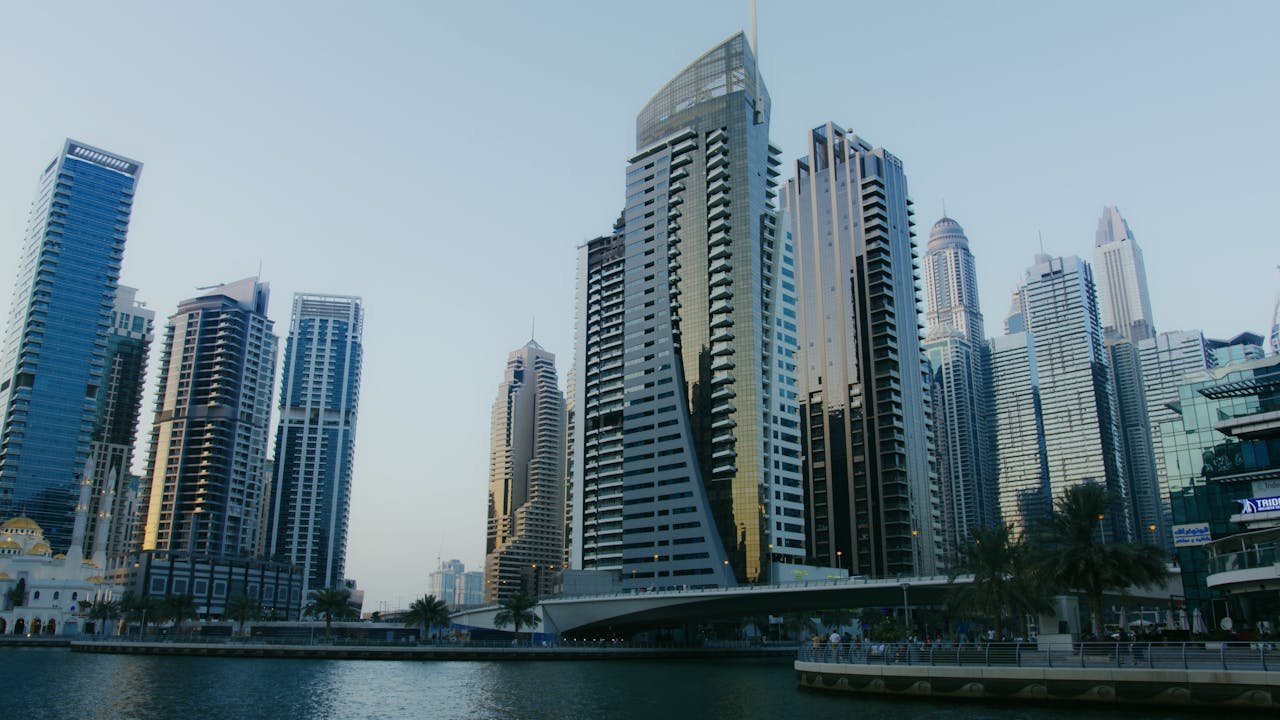 Dubai Marina skyline showcasing modern skyscrapers and waterfront view under clear sky.